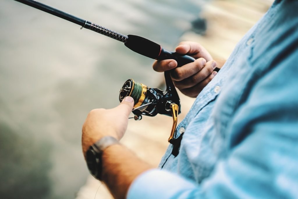 person-holding-black-and-yellow-fishing-reel-gl1jwlrvl8a As he cast off the dock, I noticed the sharp contrast between the gold from the rod and the blue in his shirt. The dock and water blurred into the background and with a click, the memory was saved.